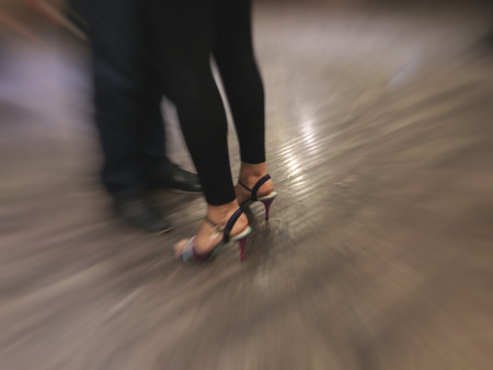 Tango dancing couple, legs in motion, snapshot in close. Blure effect.の写真素材