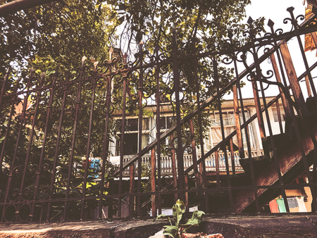 Old Tbilisi architecture, yard, windows, old iron stairs in summer day.