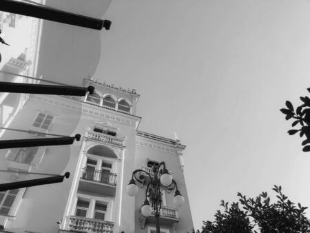 Facade of a building with columns against the sky. Bottom to top image.の写真素材