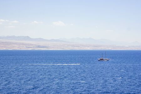 Pleasure yacht in the Red Sea against the mountains.