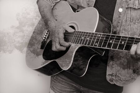 Portrait of a teenager playing guitar in studioの写真素材