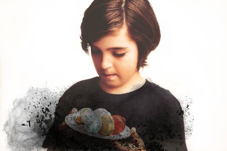 Handsome boy holds in his hands macaroni over white backgroundの写真素材