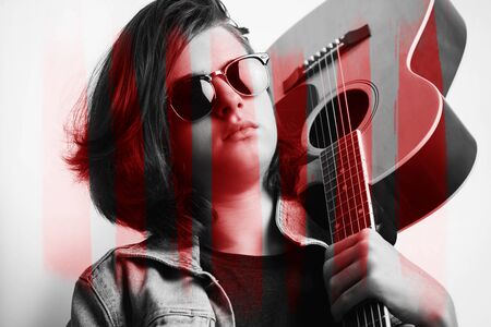 Portrait of a teenager with guitar in studio