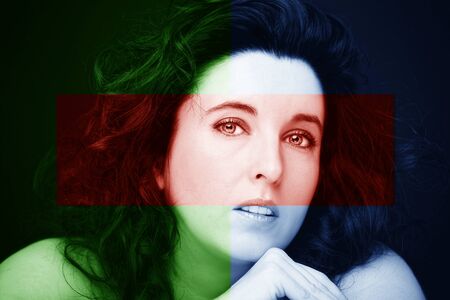 Young attractive woman with long black hair on dark background.の写真素材