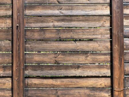A beautiful wooden fence with cracked paint. Close-up.の写真素材