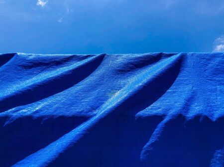 Blue background texture. Background of blue fabric and sky.の写真素材