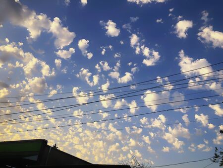 Sunset cloudy sky with picturesque clouds lit by warm sunset sunlight, colorful sunset sky with...