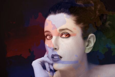 Young attractive woman with long black hair on dark background.の写真素材