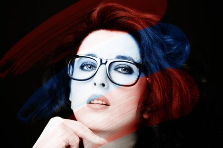 Young attractive woman with long black hair on dark background.の写真素材