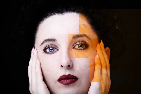 Young attractive woman with long black hair on dark background.の写真素材