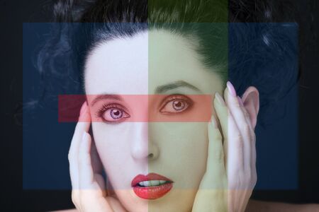 Young attractive woman with long black hair on dark background.の写真素材