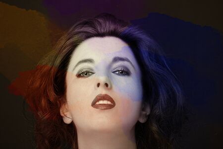 Young attractive woman with long black hair on dark background.の写真素材