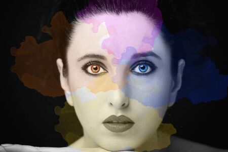 Young attractive woman with long black hair on dark background.の写真素材