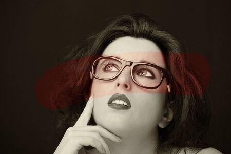 Young attractive woman with long black hair on dark background.の写真素材