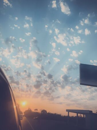 Sunset cloudy sky with picturesque clouds lit by warm sunset sunlight, colorful sunset sky with...