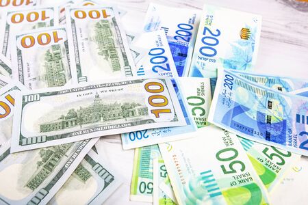 Israeli and American banknotes. Shekel and American dollarsの写真素材