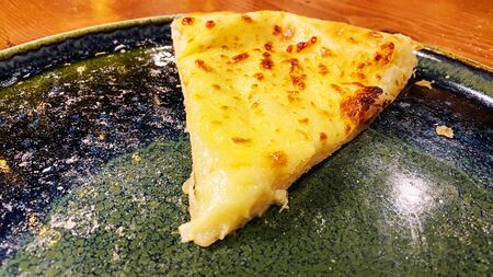 Hot Khachapuri on a plate. Khachapuri dish of Georgian cuisine.