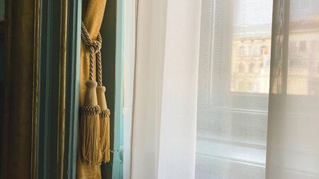 Curtain with warm sunlight close-up with decorative elementsの写真素材