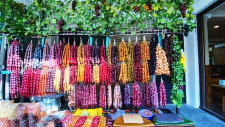 Churchkhela candies hanging in front of market stall in Tbilisi, Georgia. Churchkhela is a...