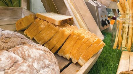 Loaves, bread, baguettes and pastries are on the counter in the store or supermarket. Freshly baked...