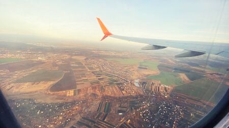 Beautiful view of the landscape from the window of an airplane. In the frame of an airplane wingの写真素材