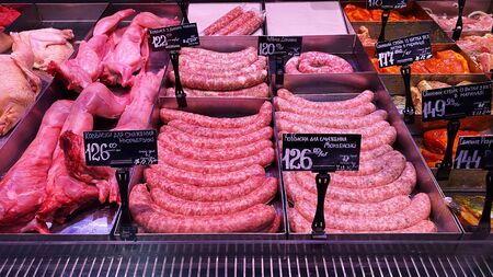 LVIV, UKRAINE - December 6, 2019: Homemade stuffed meat sausages in a store in iron containersの写真素材