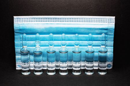 ampoules with medicine on a blue background. coronavirus vaccine, concept medicine vaccination...