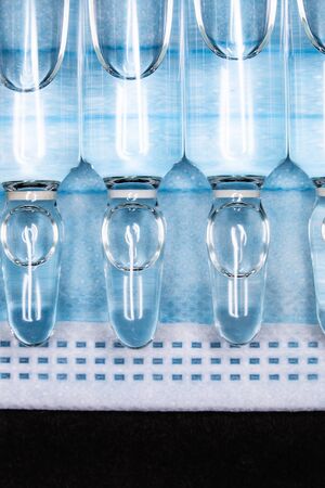 ampoules with medicine on a blue background. coronavirus vaccine, concept medicine vaccination...