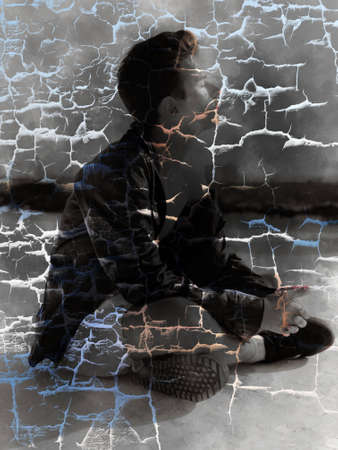 Young attractive man posing in front of camera in a dark  brown jacket on the roof of a residential building.の写真素材