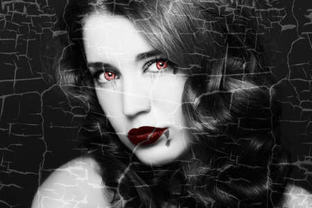 Pretty female fashion model posing in studio with dark gothic make up