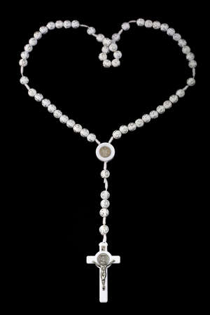 Traditional christian holy religious white rosary isolated on black background.の写真素材