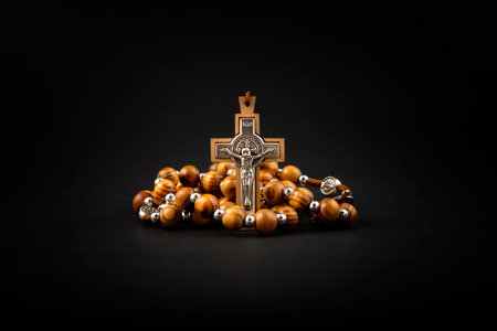 Traditional christian holy religious wooden rosary isolated on black background.の写真素材