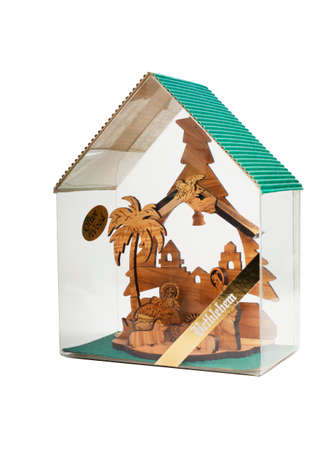 Carved wooden Nativity scene with Jesus in box isolated on white backgroundの写真素材