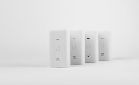 White PoE injector for electronic equipment on a white background.