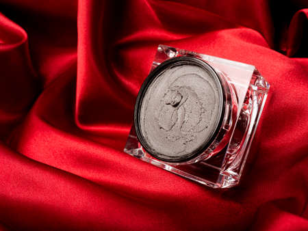 Black magnetic face mask with a piece of black magnet in the jar.の写真素材