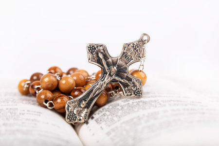 Bible with wooden rosary isolated on white backgroundの写真素材