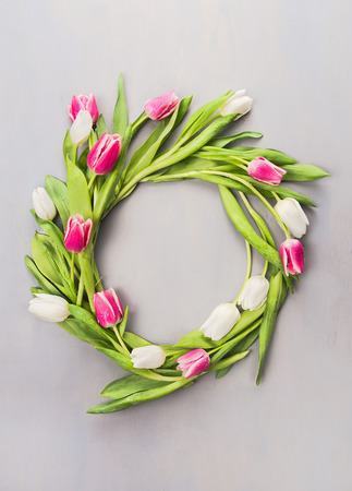 Wreath of pink and white tulips on a gray wallの写真素材