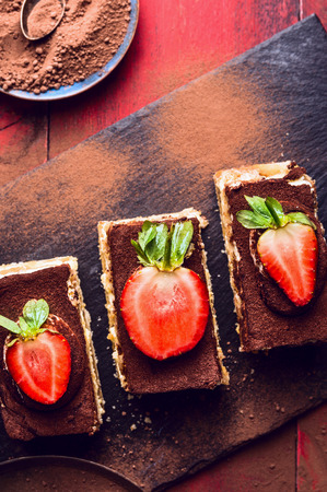 tiramisu cake with strawberries slices on slate, top viewの写真素材