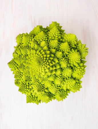 Romanesco cabbage head on white wooden background, top viewの写真素材