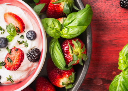 Bowl with cottage cheese,  blackberries, blueberries, strawberries and basil ,top view close upの写真素材