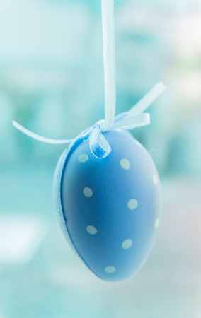 Easter egg blue polka dot with ribbon hanging, toningの写真素材