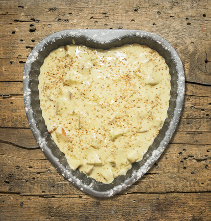 Heart shaped cake with whipped cream and berries, isolated on white backgroundの写真素材