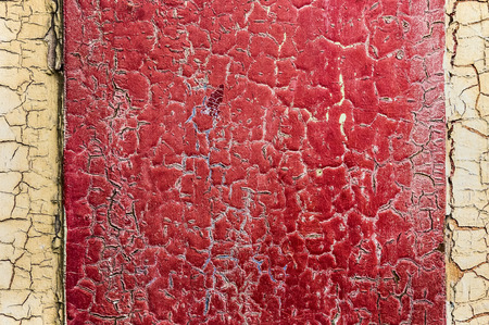 Old red beige cracked paint concrete wall texture backgroundの写真素材