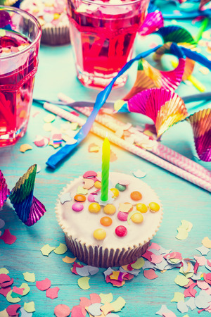 Cupcake with candle over party decor background.  Happy birthday greeting card, horizontalの写真素材