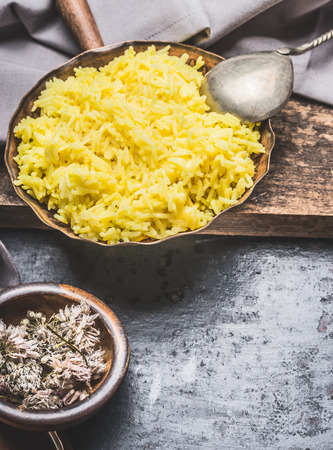 Yellow Saffron Rice , ingredients for tasty cooking on dark rustic backgroundの写真素材