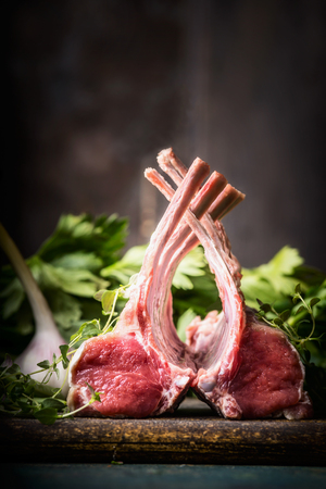 Rack of lamb on rustic kitchen table at wooden background, side viewの写真素材