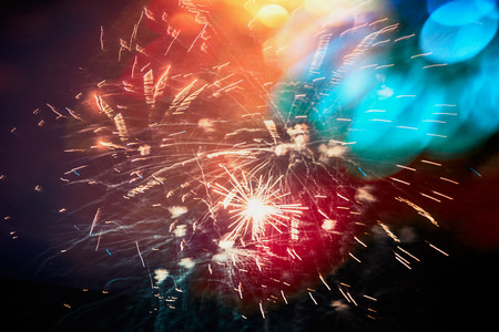 Colorful Holiday firework ob dark sky background with bokehの写真素材