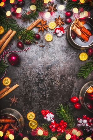 Mulled wine and ingredients spices with fir branches and Christmas decoration and bokeh  on dark rustic background, top view frameの写真素材
