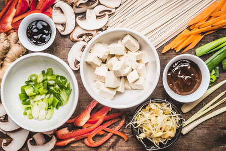 Top view of Asian vegetarian cooking ingredients for stir fry with tofu, noodles and vegetablesの写真素材