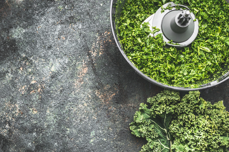Chopped kale leaves for salad making, cooking on rustic background , top view, place for text. Vegan or vegetarian nutrition, diet, detox and healthy food conceptの写真素材